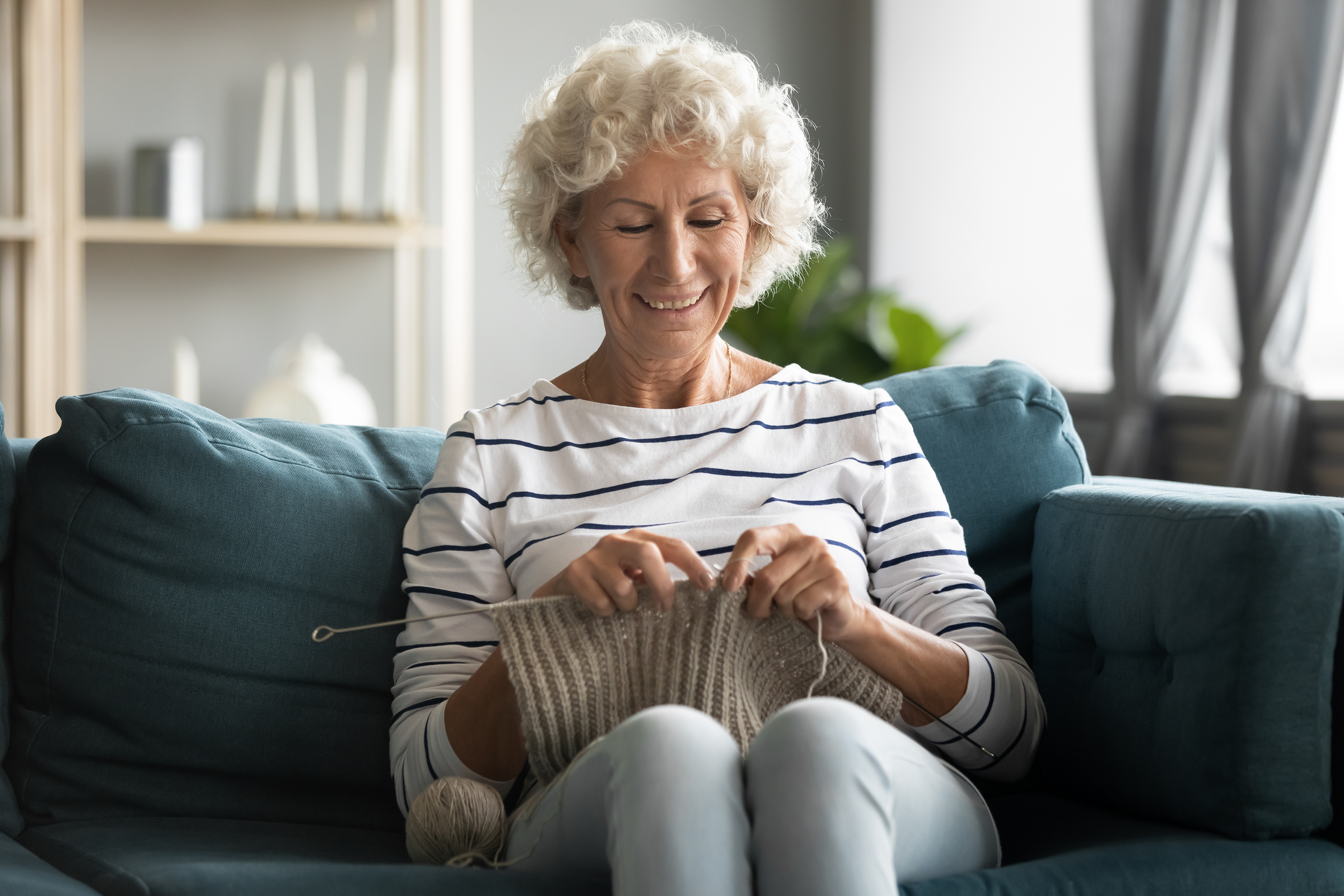 Woman knitting because of treated arthritis pain.